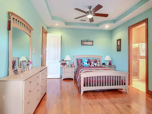 kids bedroom example before virtual staging, bright blue walls and stuffed animals